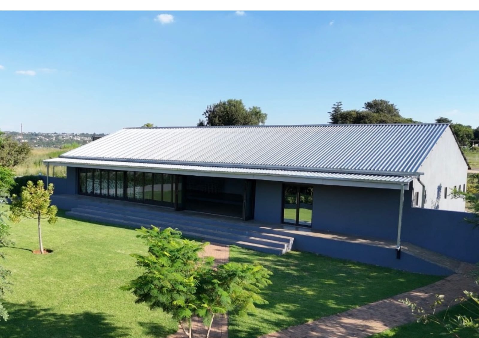 Lufuno Main Hall exterior, a modern event hall with manicured lawns at Muano Functions Venue