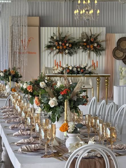 Lufuno Main Hall wedding at Muano with orange and white florals, gold candlesticks and crystal chandelier